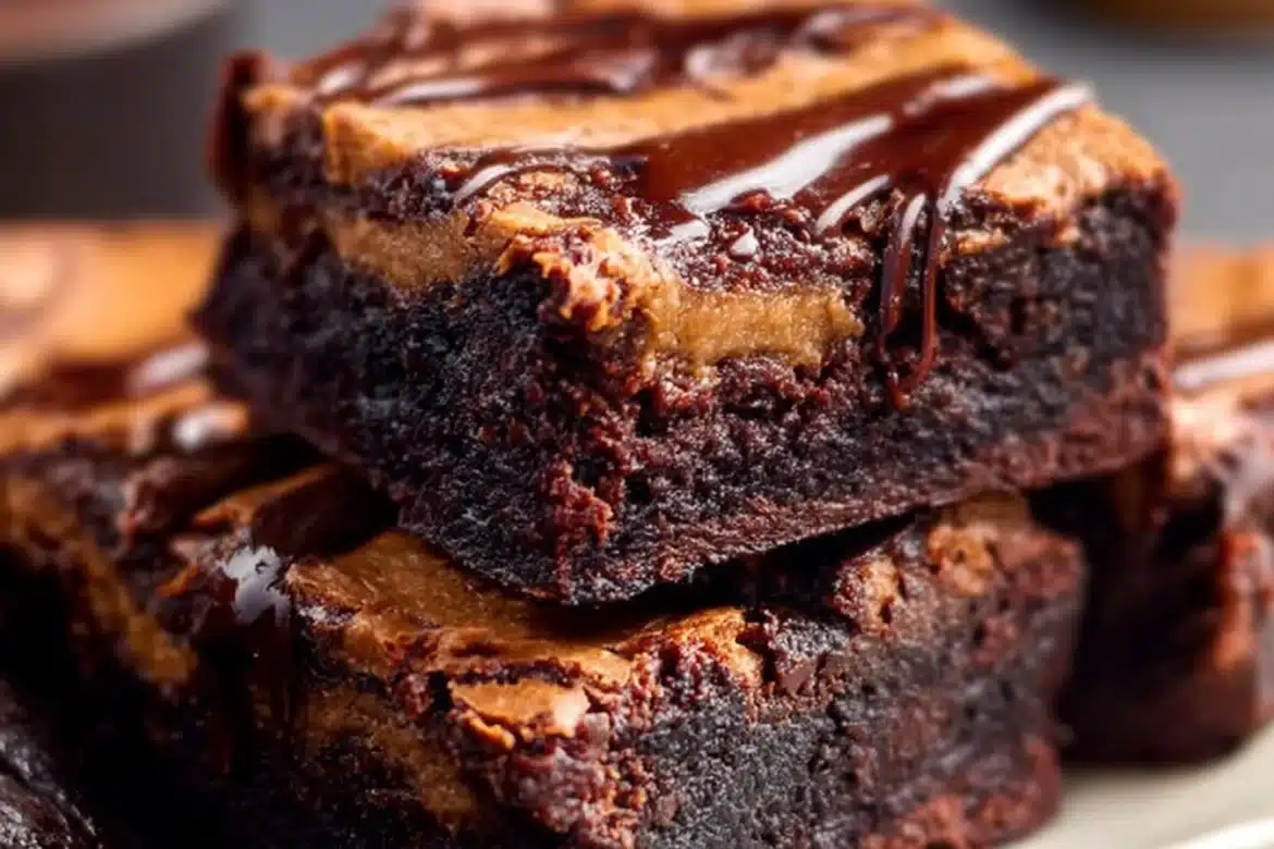 Delicious pumpkin brownies topped with chocolate frosting on a wooden table.