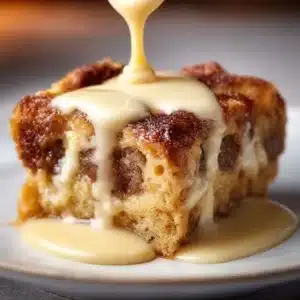 Delicious classic bread pudding served with a drizzle of caramel sauce