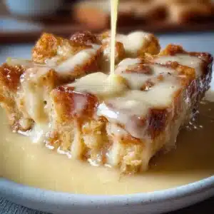 Delicious bread pudding served with creamy vanilla sauce