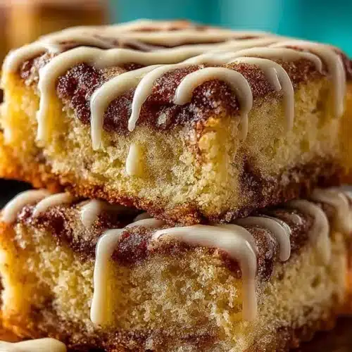 Delicious Cinnabon Cinnamon Roll Cake freshly baked and topped with creamy frosting