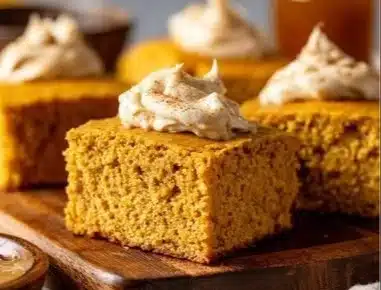 Slice of Pumpkin Cornbread with Cinnamon Honey Butter on a wooden table