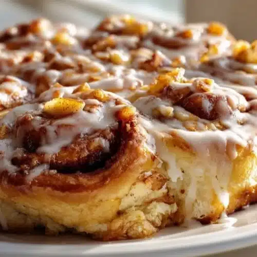 Delicious Sweet Apple Pie Cinnamon Roll Bake topped with icing and cinnamon